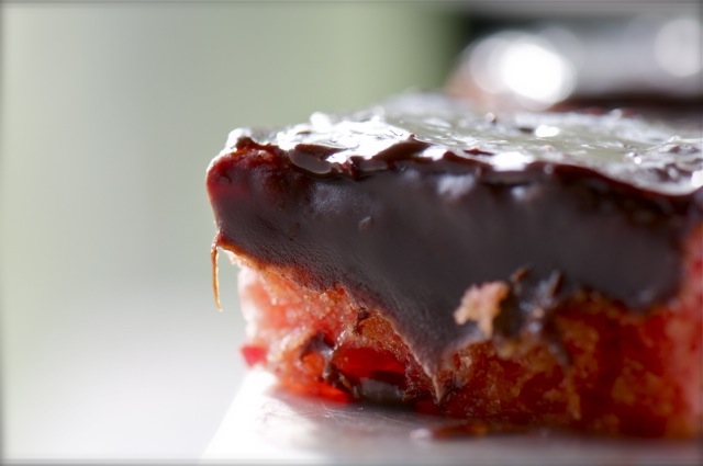 Namely_Marly_Chocolate_Covered_Strawberry_Cake1 A straweberry cake topped with chocolate fudge icing is backlit by the morning sun.